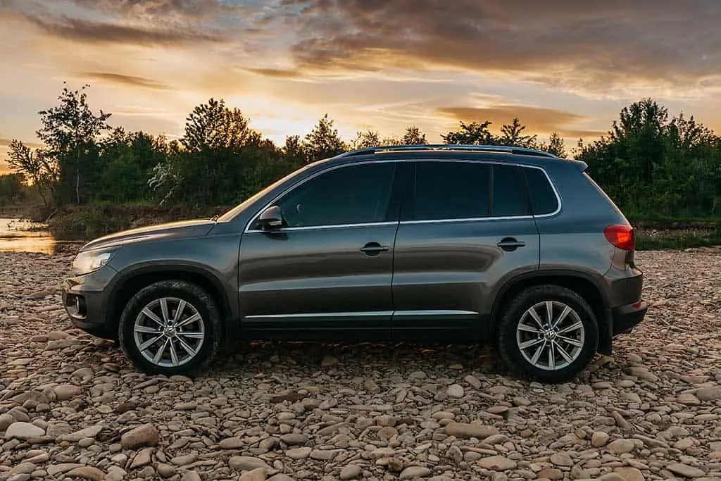 A customer's Volkswagen SUV parked next to a lake. 