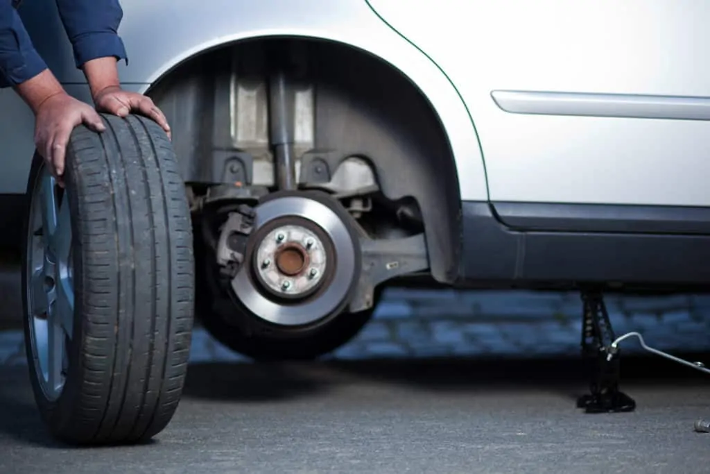 Replacing a customer's tire on the side of the road in Mays Landing