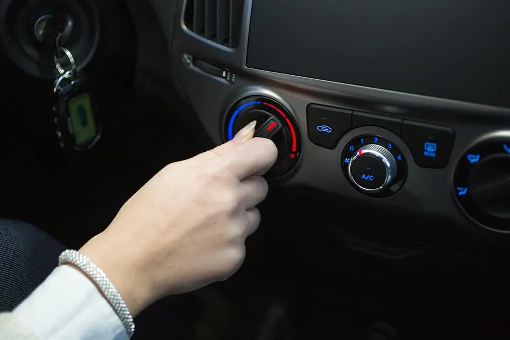 Woman turning on car heater in Mays Landing, NJ